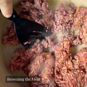 meat being browned in a pot 