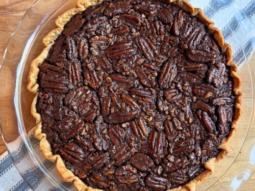 Old fashioned chocolate pecan pie on a blue and white towel