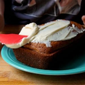 Putting icing on pumpkin cranberry bread
