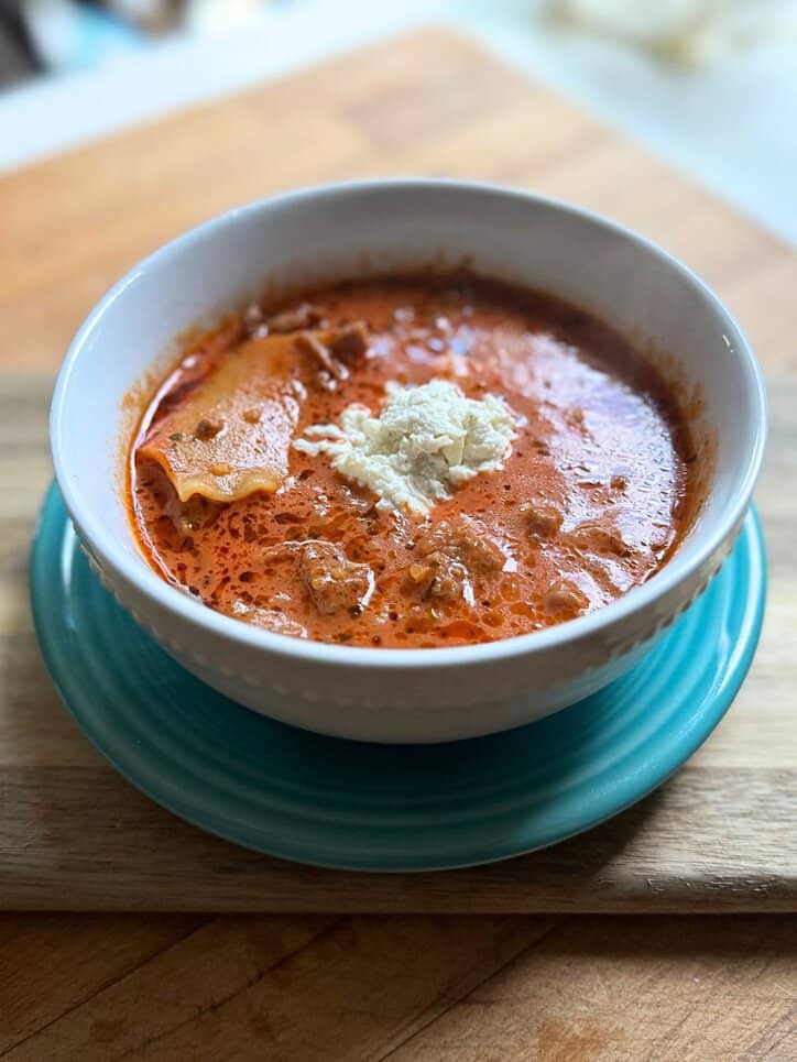 omato based soup in a white bowl on a blue plate