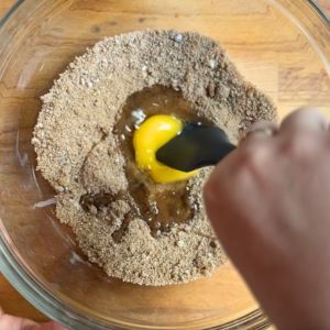 Adding eggs to sugar mixture