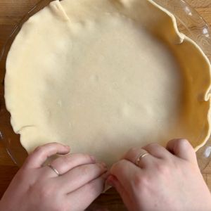 putting pie crust in a pie plate