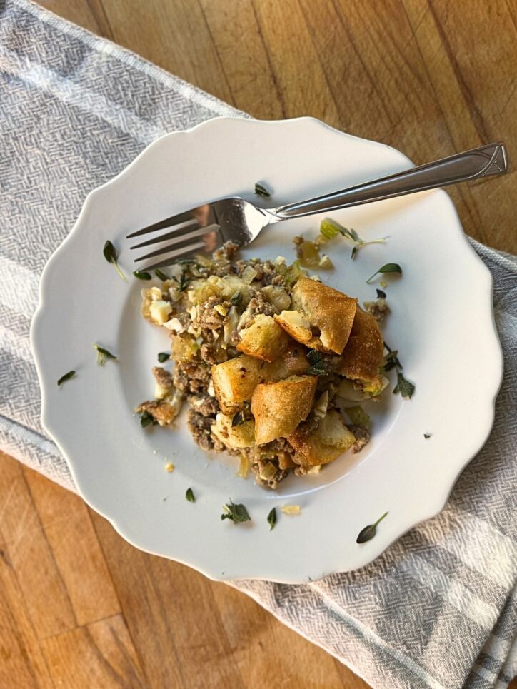 Traditional Stuffing on a white plate with a fork