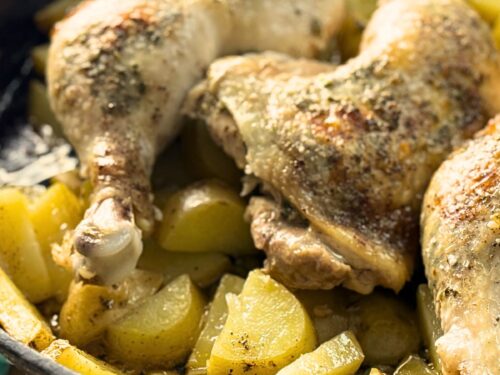 Whole chicken legs roasted over potatoes