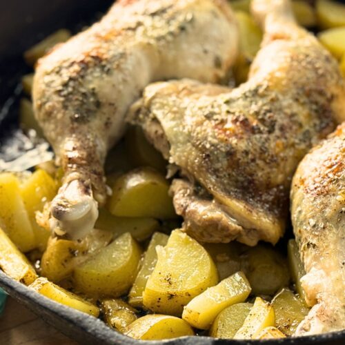 Whole chicken legs roasted over potatoes