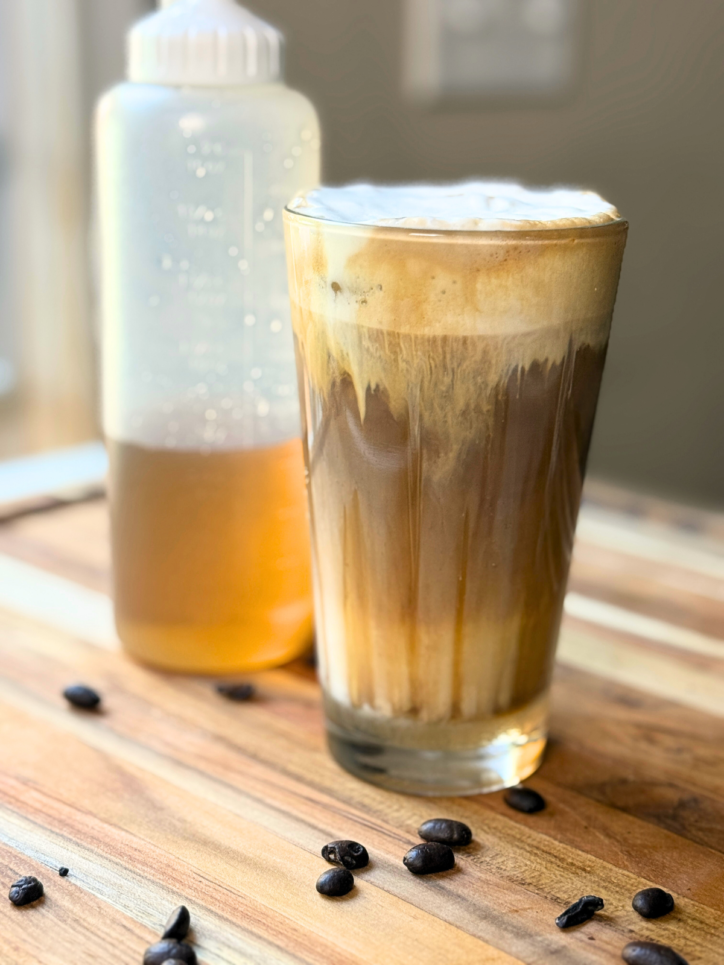 cup of iced coffee with sugar cookie syrup in a squeeze bottle