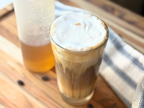 Sugar cookie latte with a squeeze bottle of homemade sugar cookie syrup