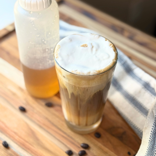 Sugar cookie latte with a squeeze bottle of homemade sugar cookie syrup