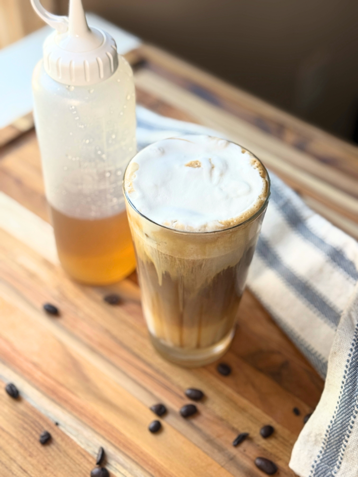 Sugar cookie latte with a squeeze bottle of homemade sugar cookie syrup