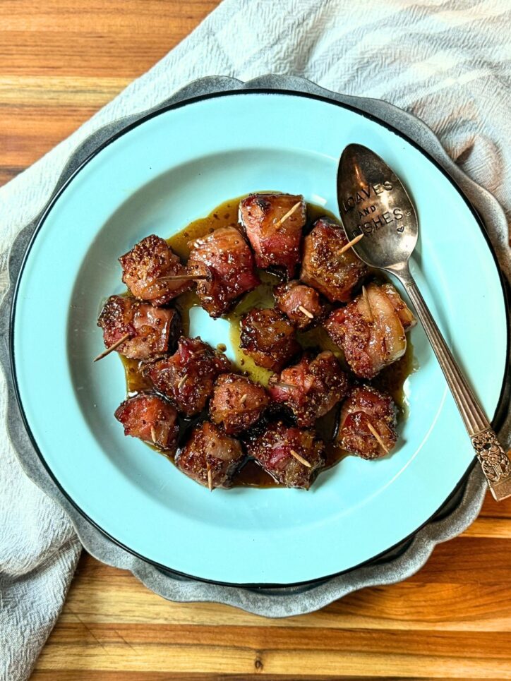 Bacon wrapped andouille sausage bites with a brown sugar sauce on top